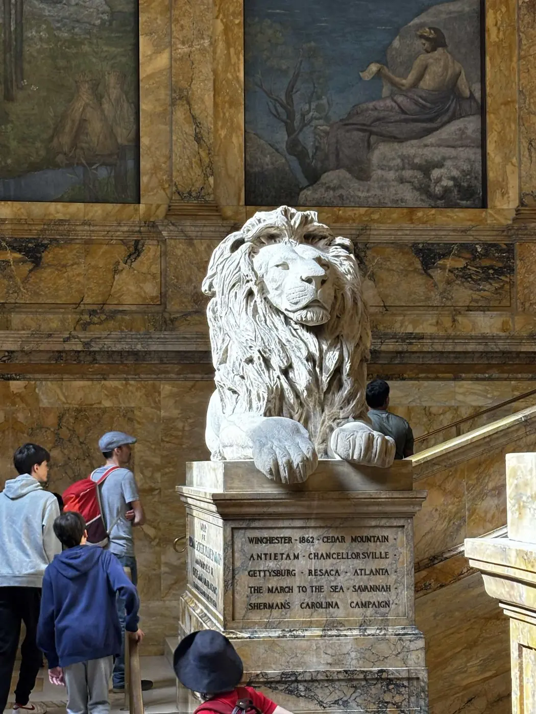 A white stone lion monument in a marble hall, inscribed with Civil War battle names